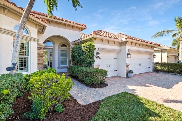 mediterranean / spanish-style home with a garage