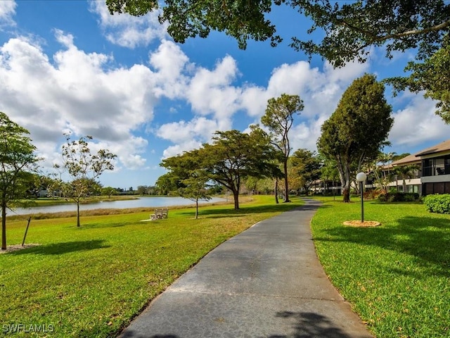 view of home's community featuring a water view and a yard