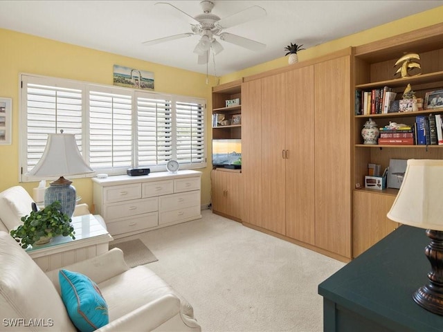 interior space featuring light colored carpet and ceiling fan