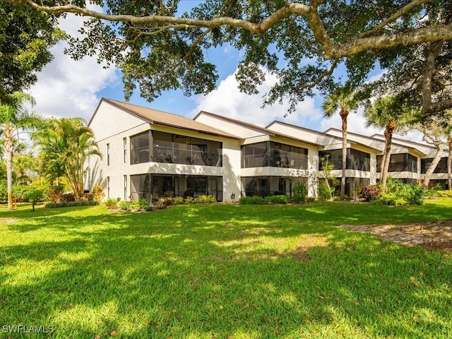 rear view of property featuring a yard