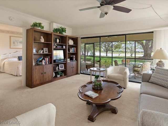 living room featuring ornamental molding, plenty of natural light, carpet, and ceiling fan