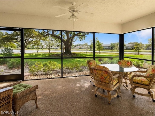 sunroom featuring ceiling fan