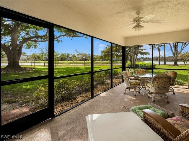 sunroom / solarium with a wealth of natural light and ceiling fan