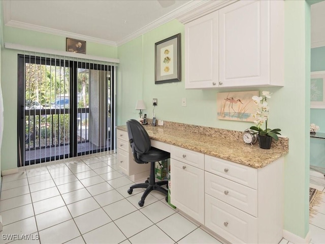 office area with crown molding, built in desk, and light tile patterned floors