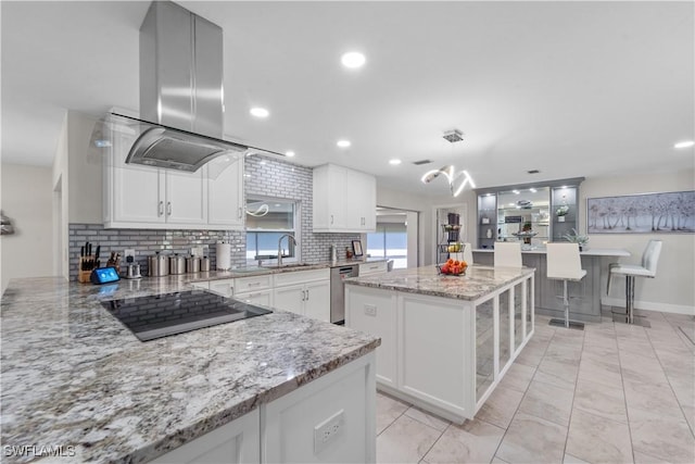 4476 Windjammer Ln, Fort Myers, FL 33919 - kitchen featuring black electric cooktop, island range hood, white cabinets, and a sink