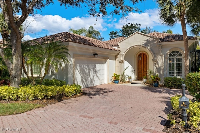 mediterranean / spanish house with a garage