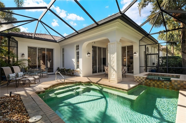 rear view of house with a lanai, a pool with hot tub, and a patio area