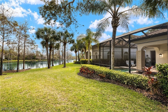 view of yard featuring a lanai and a water view