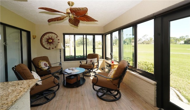 sunroom with a ceiling fan and plenty of natural light