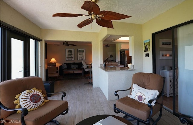 interior space featuring a sink and a ceiling fan