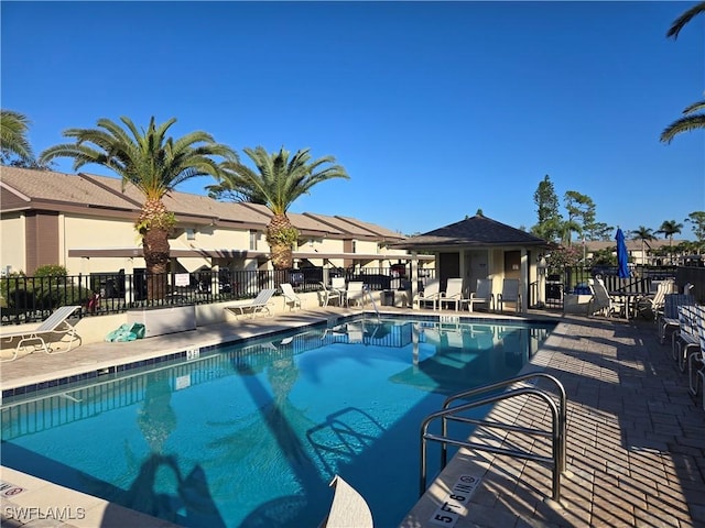 pool featuring fence and a patio