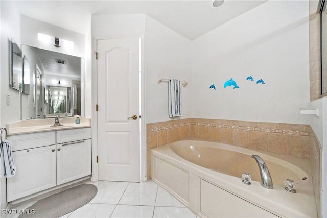 bathroom featuring a washtub, vanity, and tile patterned floors