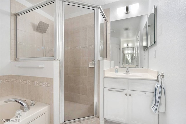 bathroom with vanity and separate shower and tub