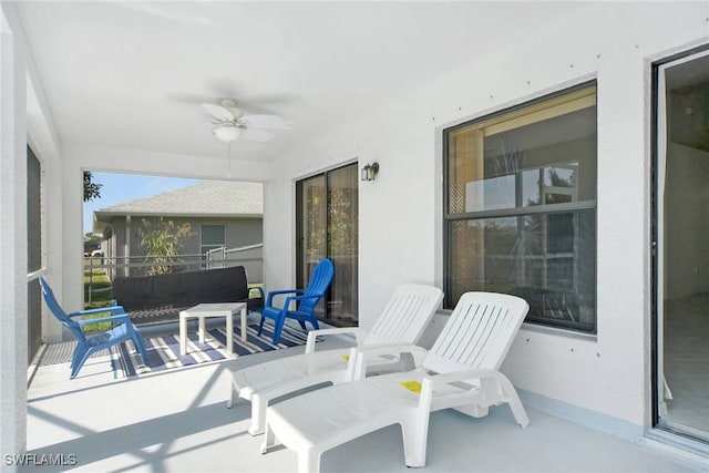 view of patio featuring a balcony and ceiling fan