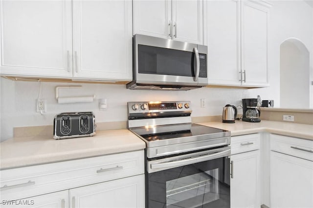 kitchen featuring appliances with stainless steel finishes and white cabinets