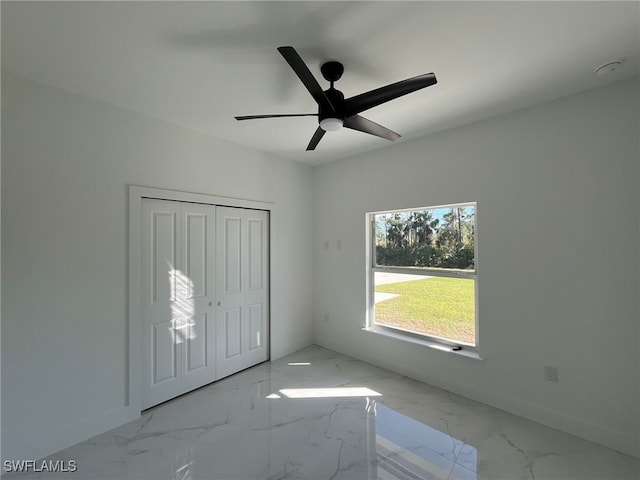 unfurnished bedroom with a closet and ceiling fan