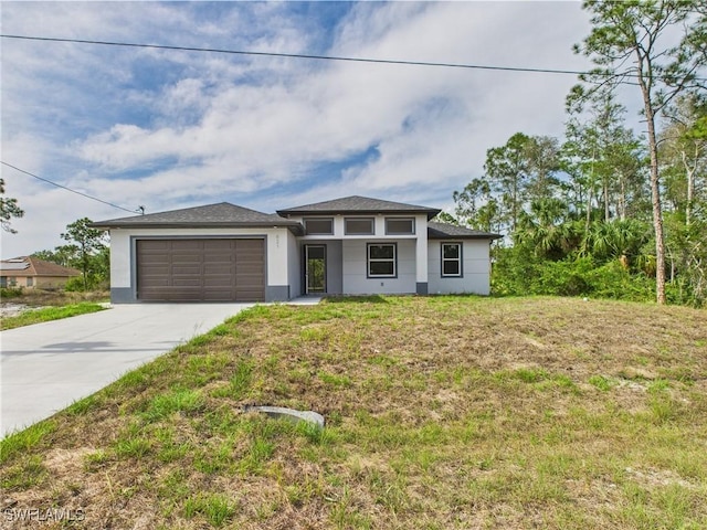 621 Allison St E, Lehigh Acres, FL 33974 - prairie-style home with a garage, stucco siding, a front lawn, and driveway