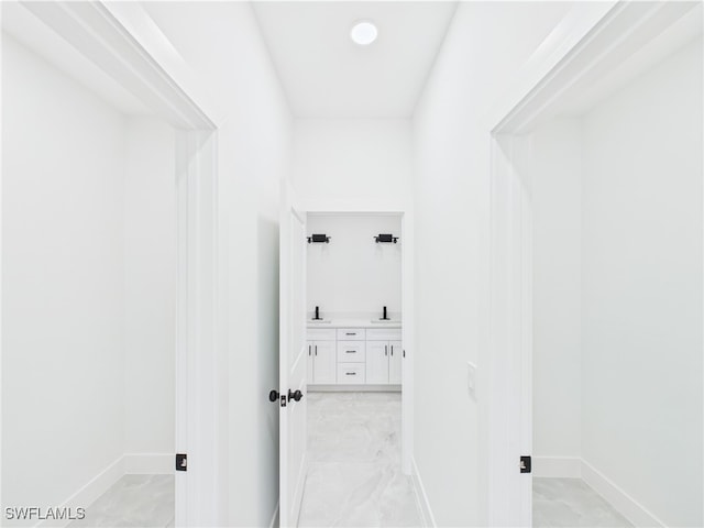 621 Allison St E, Lehigh Acres, FL 33974 - corridor with a sink, baseboards, and marble finish floor