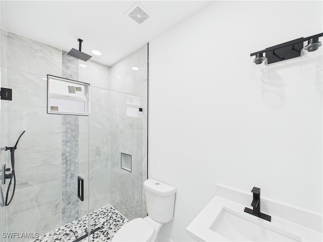 621 Allison St E, Lehigh Acres, FL 33974 - full bathroom with toilet, visible vents, a marble finish shower, and a sink