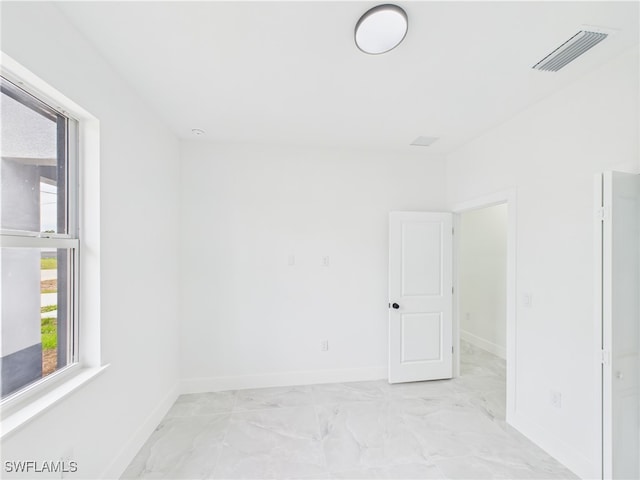 621 Allison St E, Lehigh Acres, FL 33974 - empty room with baseboards, marble finish floor, and visible vents