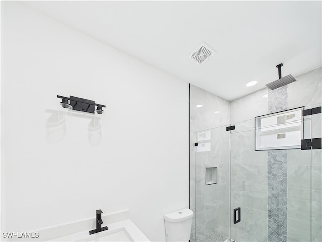 621 Allison St E, Lehigh Acres, FL 33974 - bathroom featuring a stall shower, toilet, a sink, and visible vents