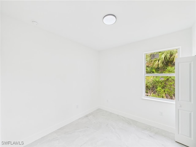 621 Allison St E, Lehigh Acres, FL 33974 - spare room featuring baseboards and marble finish floor