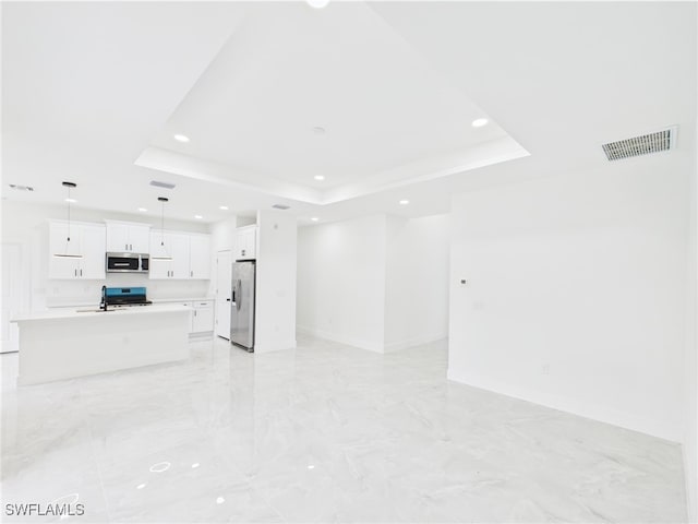 621 Allison St E, Lehigh Acres, FL 33974 - unfurnished living room featuring a sink, a tray ceiling, visible vents, marble finish floor, and recessed lighting