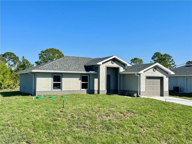 ranch-style house featuring a garage and a front lawn