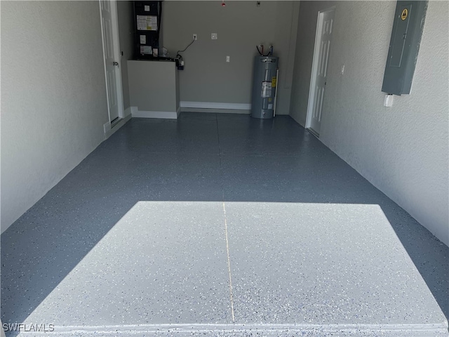 garage featuring heating unit, electric panel, and electric water heater