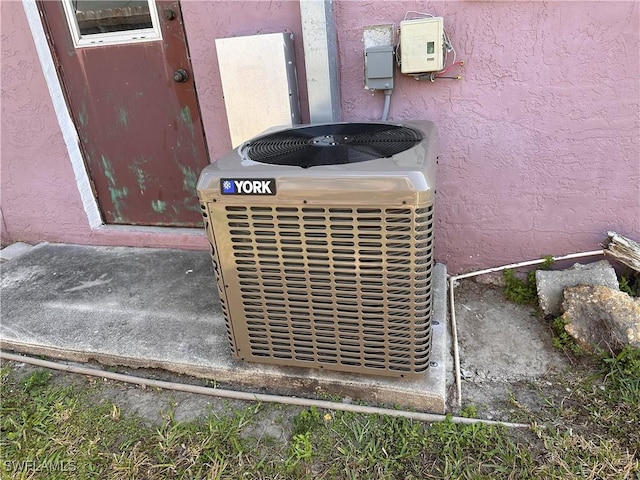 exterior details with cooling unit and stucco siding