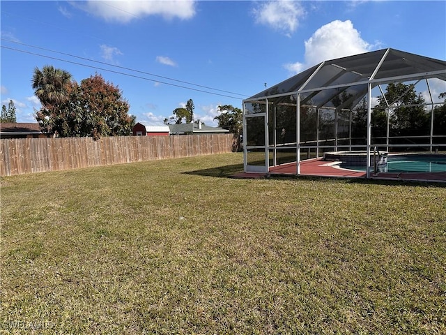 view of yard with a lanai and a fenced in pool