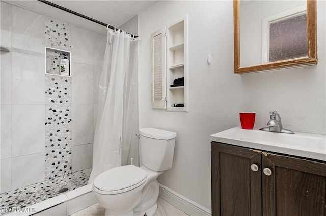 bathroom with toilet, a shower stall, baseboards, and vanity