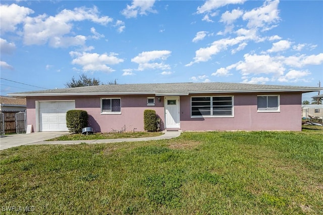 single story home with a garage, driveway, a front yard, and stucco siding