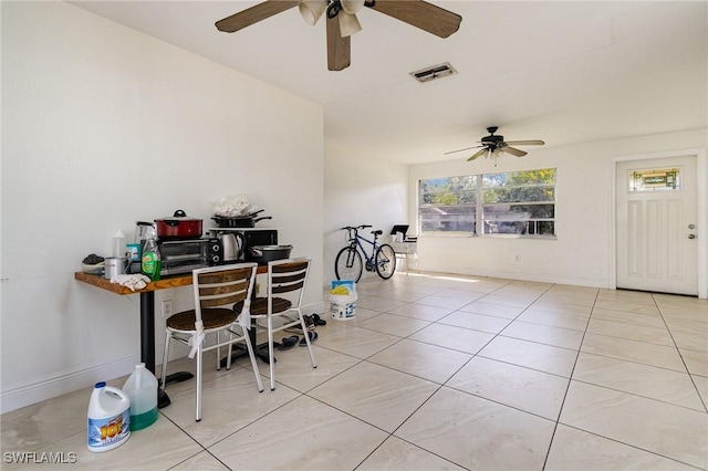 office area featuring light tile patterned floors, baseboards, visible vents, and a ceiling fan