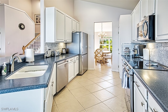 kitchen featuring white cabinetry, sink, stainless steel appliances, and light tile patterned flooring