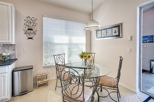 dining space featuring light tile patterned floors