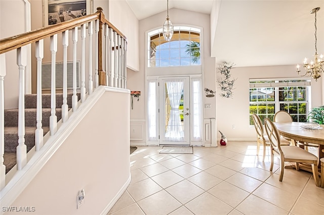 foyer featuring an inviting chandelier, plenty of natural light, and light tile patterned flooring