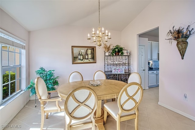 tiled dining area with vaulted ceiling, a healthy amount of sunlight, and an inviting chandelier