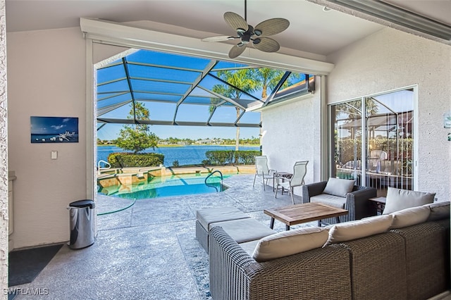 view of patio / terrace featuring a water view, outdoor lounge area, ceiling fan, and glass enclosure