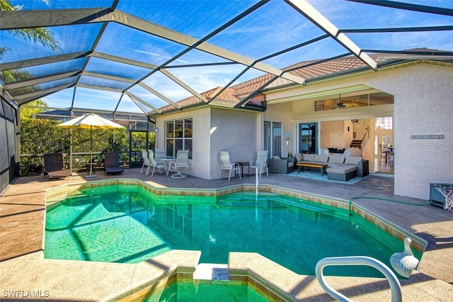 view of pool with a lanai, an outdoor hangout area, and a patio area