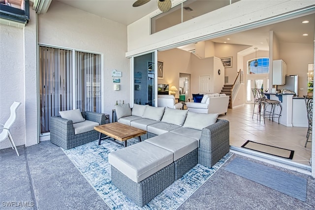 view of patio / terrace with exterior bar, ceiling fan, and outdoor lounge area