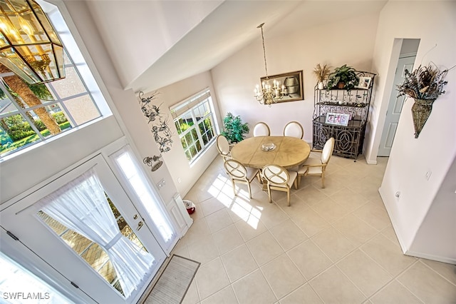 dining space with an inviting chandelier, light tile patterned floors, and a high ceiling