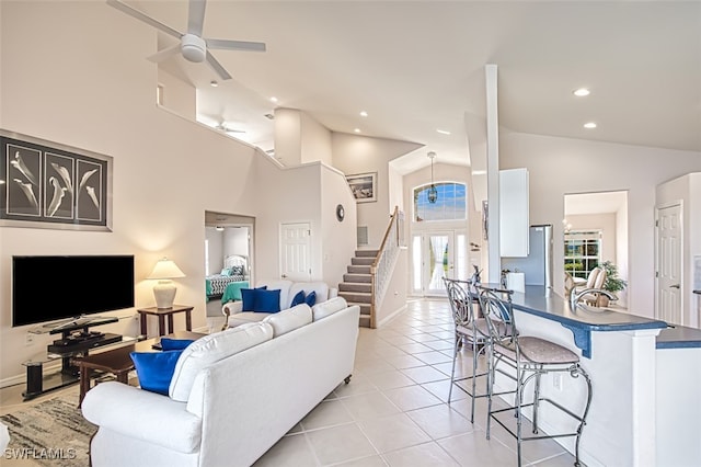 tiled living room with high vaulted ceiling and ceiling fan