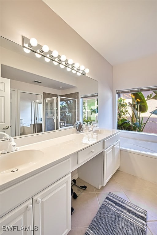 bathroom featuring vanity, tile patterned floors, and shower with separate bathtub