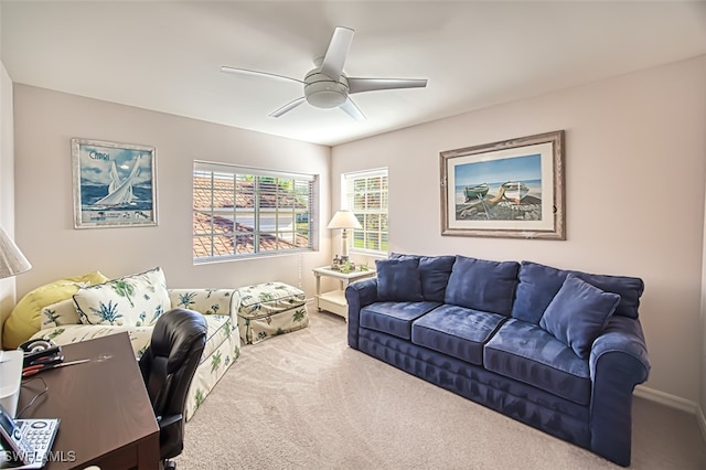 carpeted living room with ceiling fan