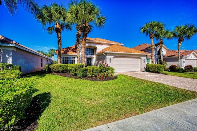 mediterranean / spanish home with a front yard