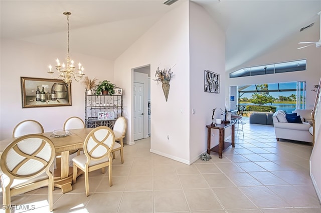 dining room with light tile patterned flooring, a chandelier, and high vaulted ceiling