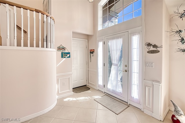 tiled foyer entrance featuring a high ceiling