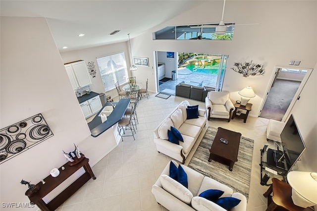 living room featuring light tile patterned floors and ceiling fan