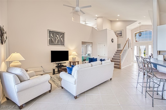 living room featuring ceiling fan, high vaulted ceiling, and light tile patterned floors